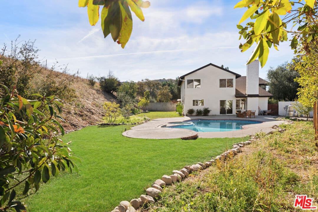 Pool, spa, and open hillside setting at 26004 Redbluff Drive
